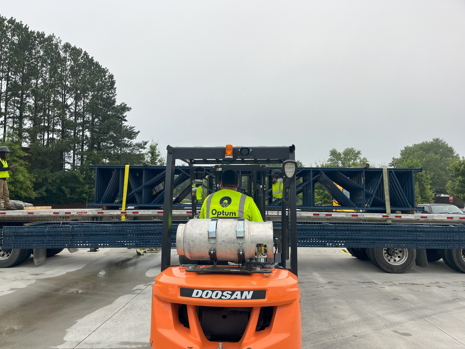 Optum worker operating forklift during racking installation