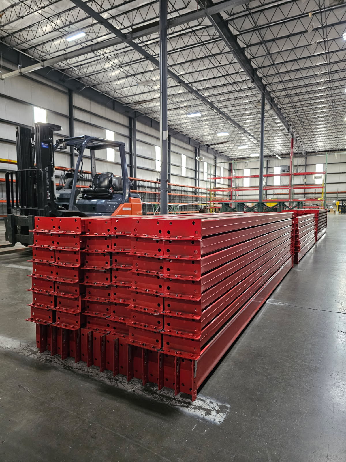 Red warehouse racking beams ready for installation