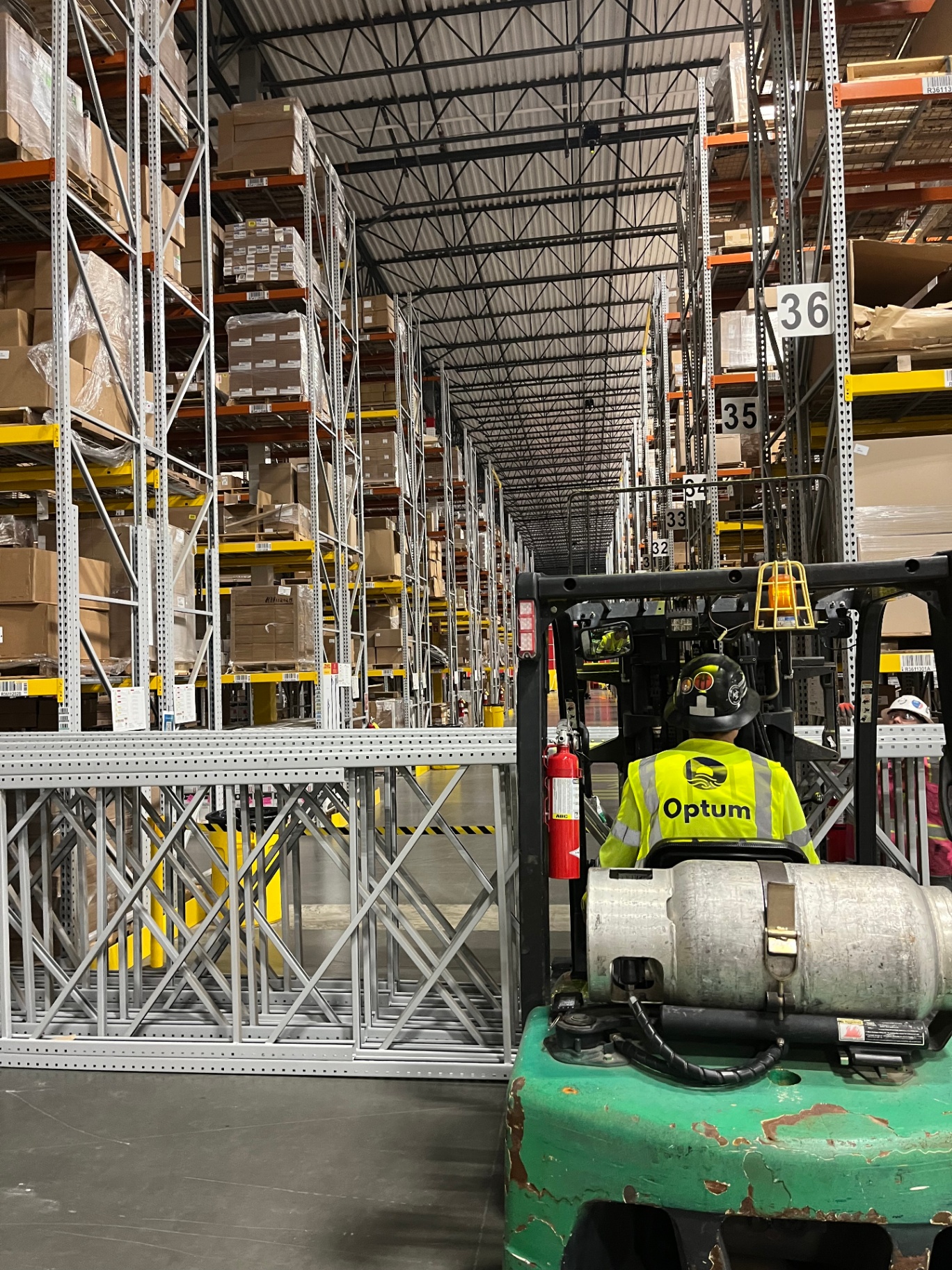 Optum installation crew member operating forklift in warehouse