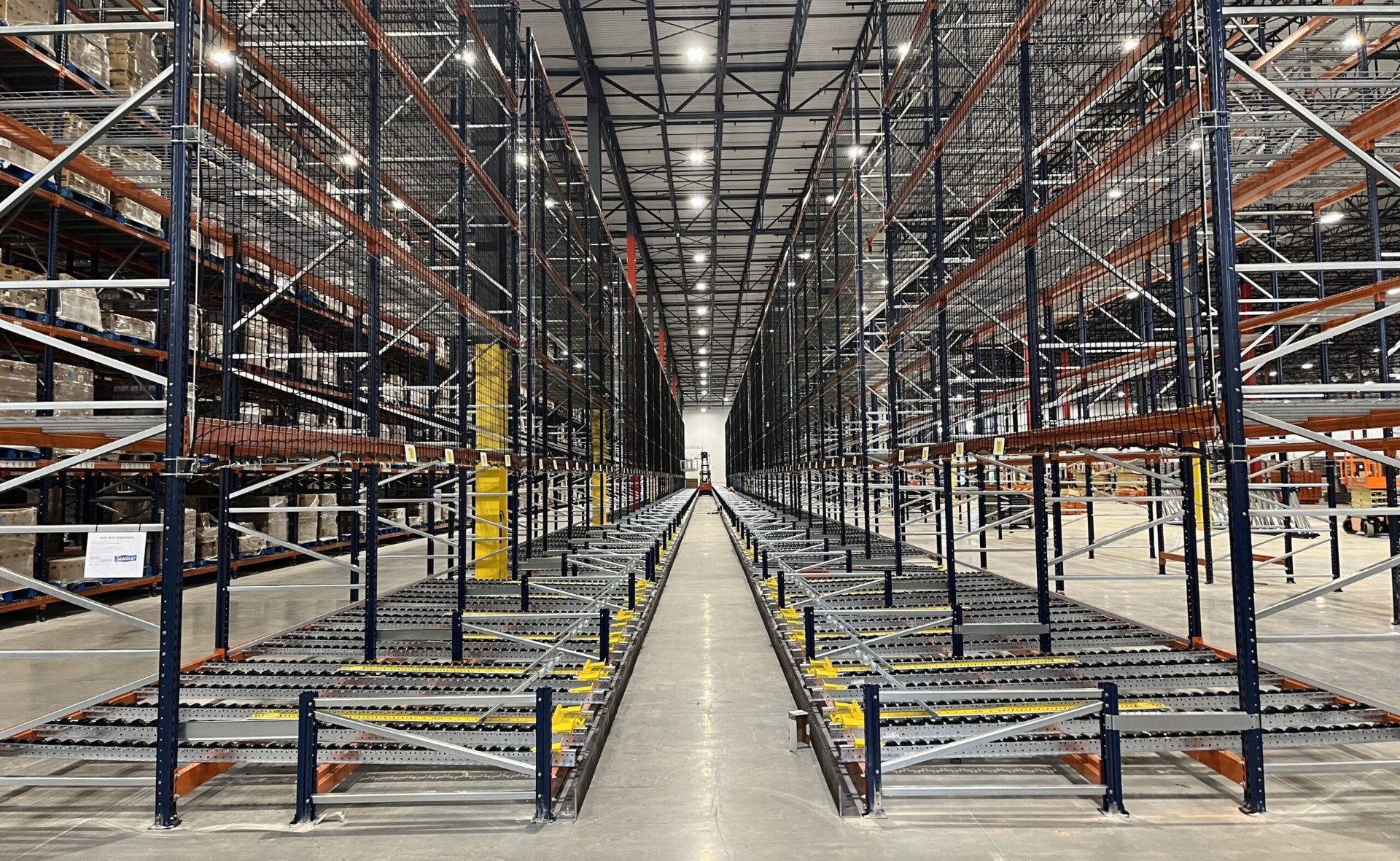 Pallet flow gravity racking system with roller lanes