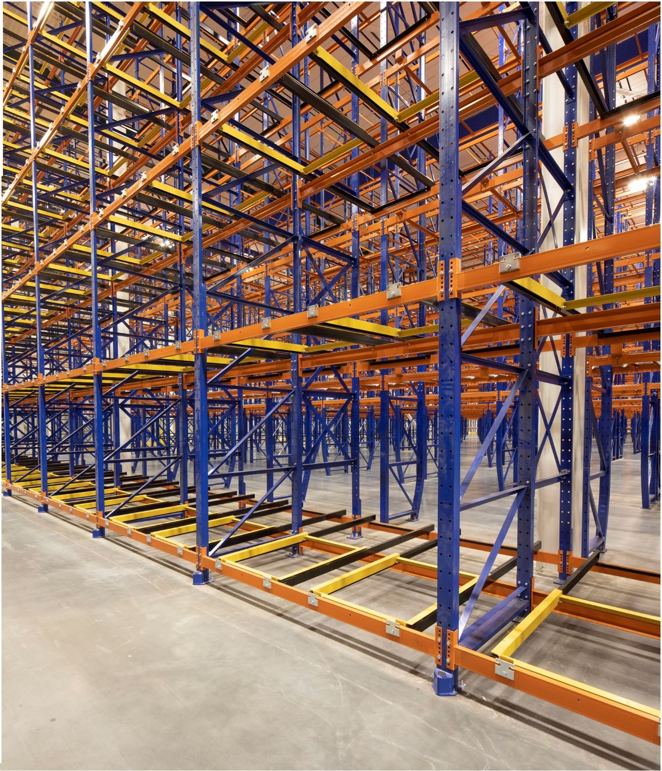 Pushback racking system with blue frames and orange rails