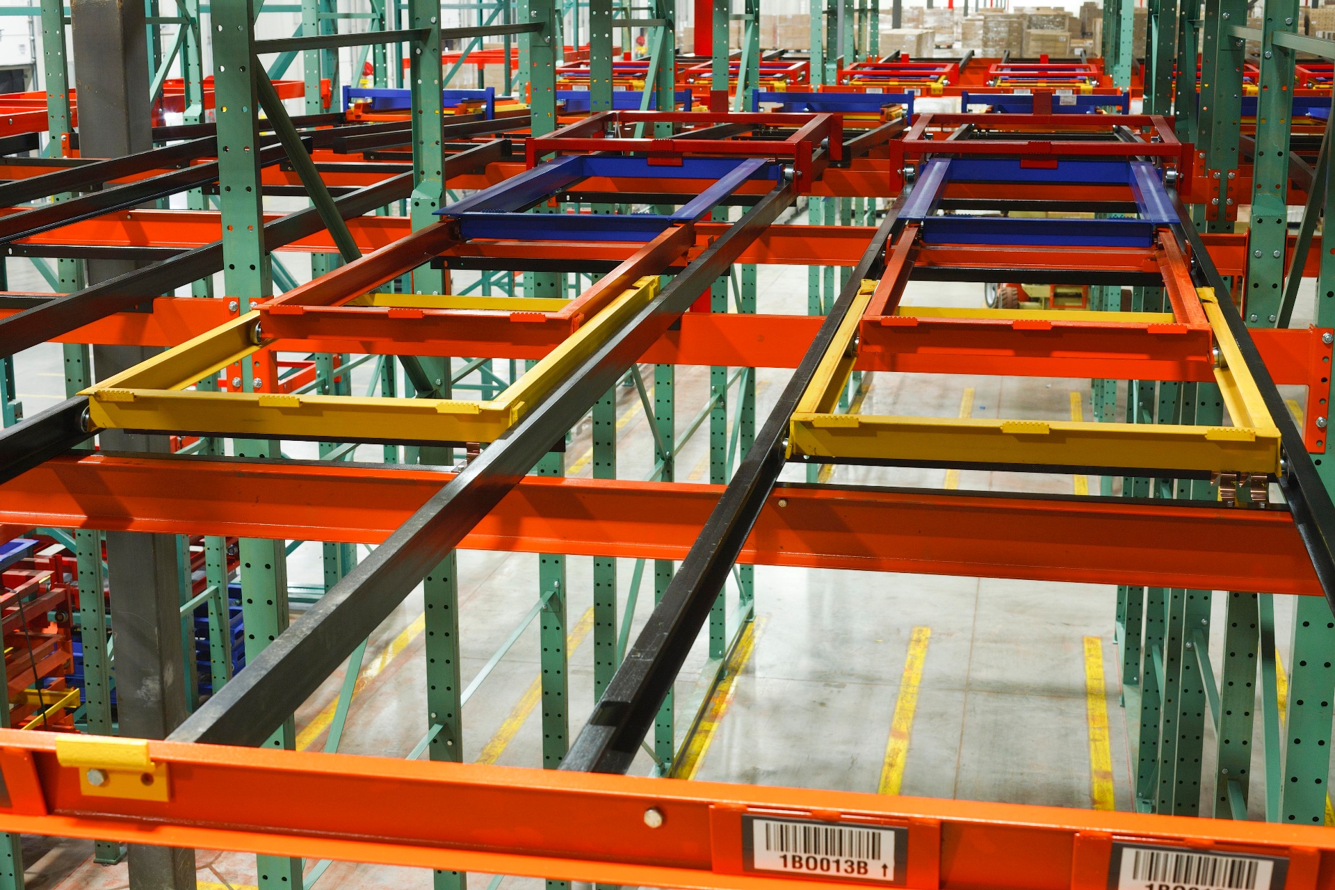 Close-up view of pushback cart mechanism with yellow and blue carts