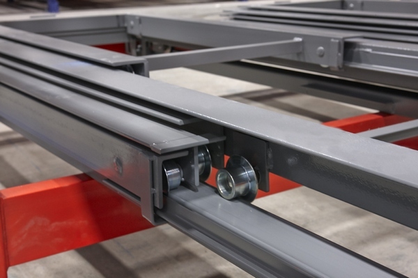 Detail of pushback cart rollers and track system