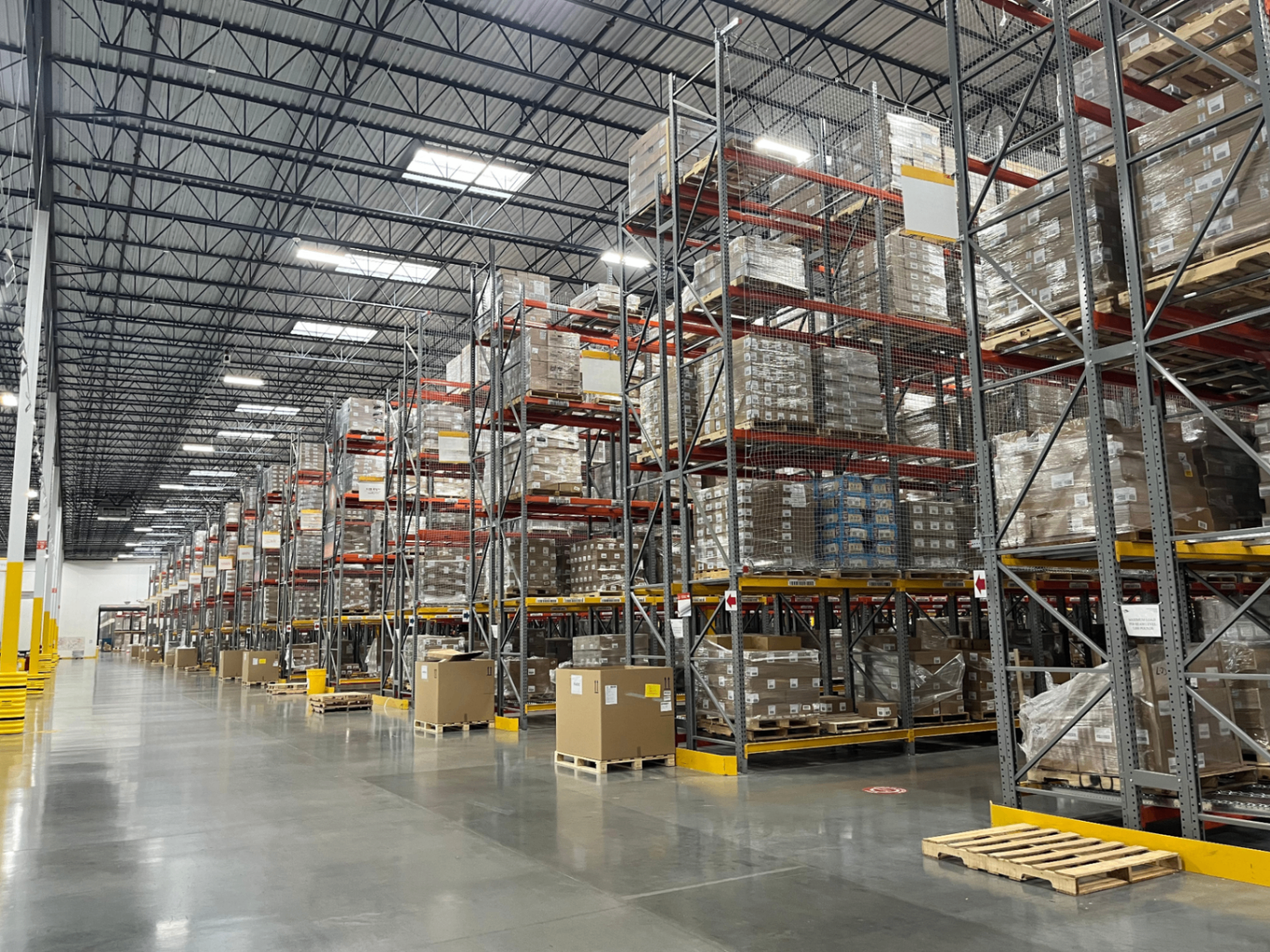 Wide view of selective racking warehouse with safety netting